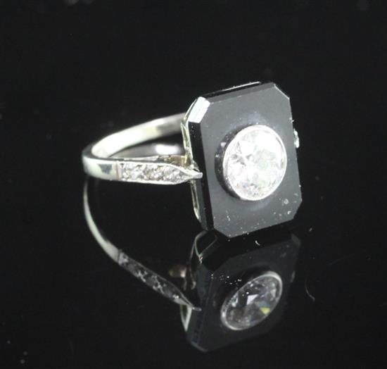 A 1930s/1940s 18ct white gold, onyx and single stone diamond tablet ring, size I.